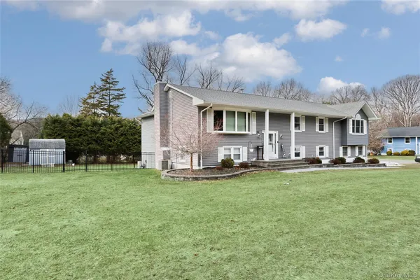 a front view of house with yard and outdoor seating
