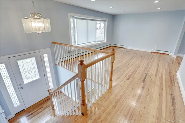 a view of an entryway with wooden floor