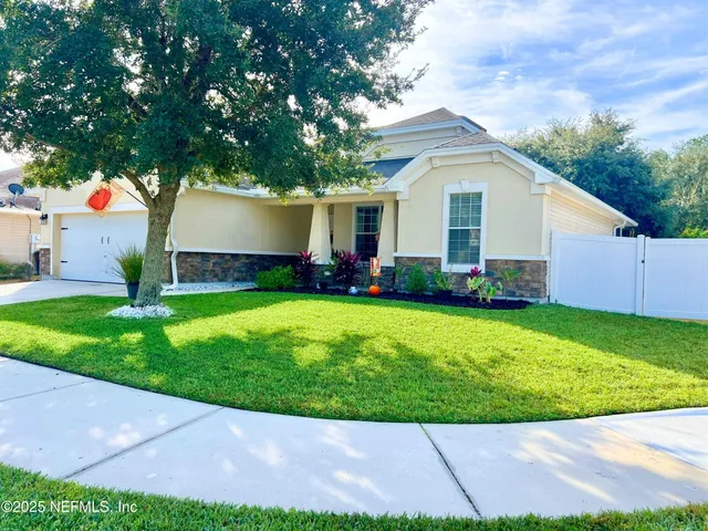a front view of house with yard and green space