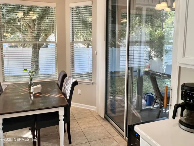 a dining room with furniture and a potted plant