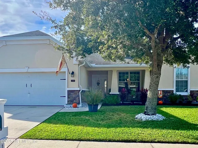 a front view of a house with garden