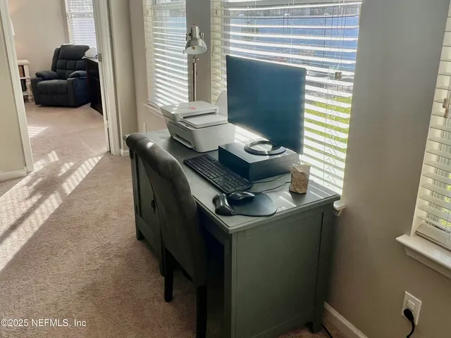 a workspace with furniture and window