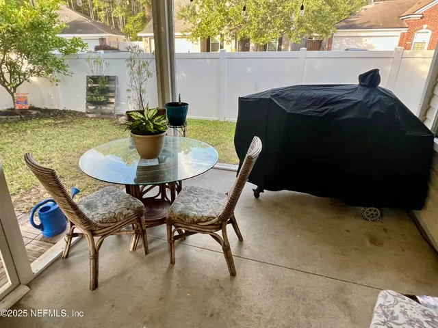 a backyard of a house with table and chairs