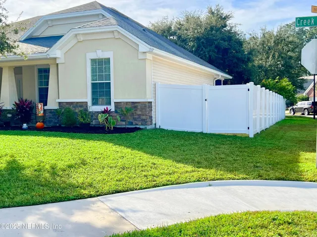 a view of a house with a yard and plants