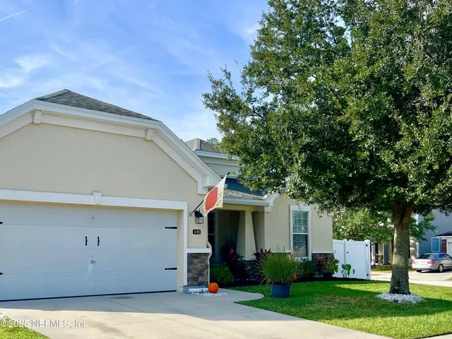 a front view of house with yard and green space