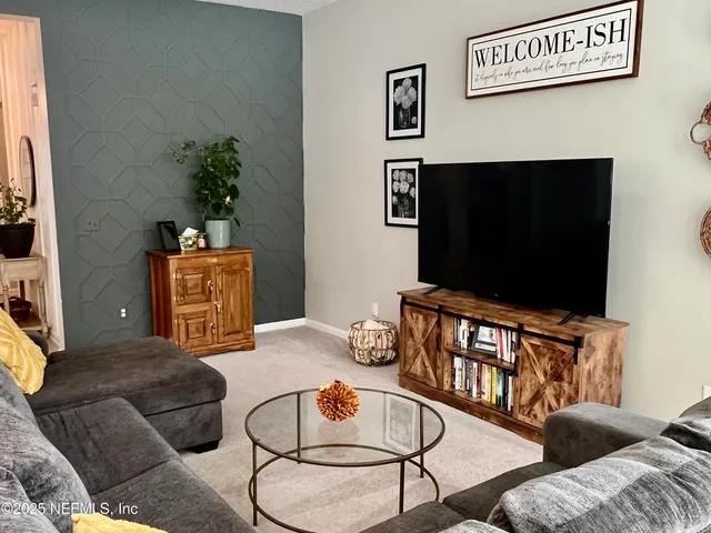 a living room with furniture and a flat screen tv