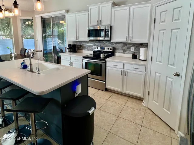 a kitchen with a sink cabinets and appliances