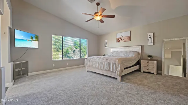 a bedroom with a bed and a television