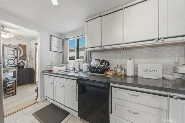 a kitchen with stainless steel appliances granite countertop a sink and cabinets