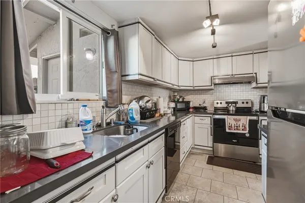 a kitchen with cabinets and appliances