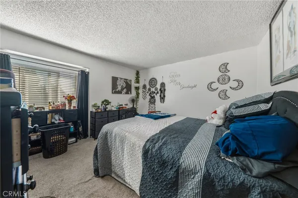 a bed room with a bed window and a couch