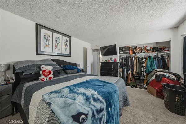 a bedroom with bed and a closet