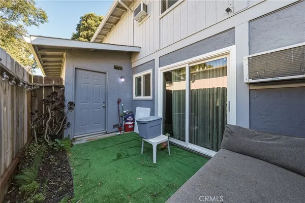 a view of a chair and table in backyard of the house