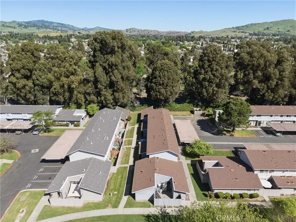 an aerial view of residential houses with outdoor space and street view