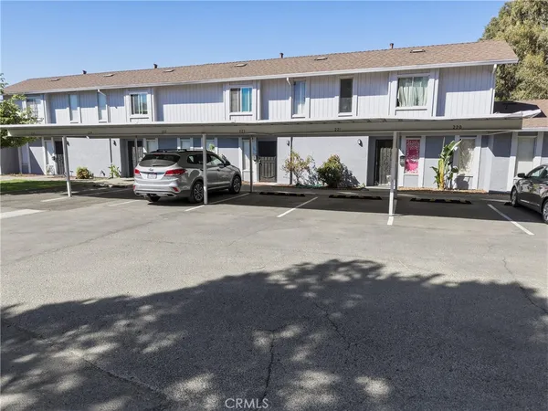 a front view of building with cars parked