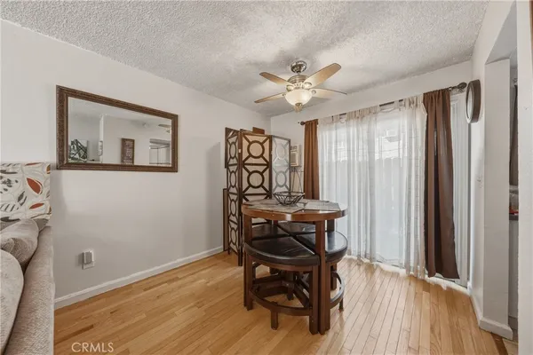 a view of a workspace with furniture and wooden floor