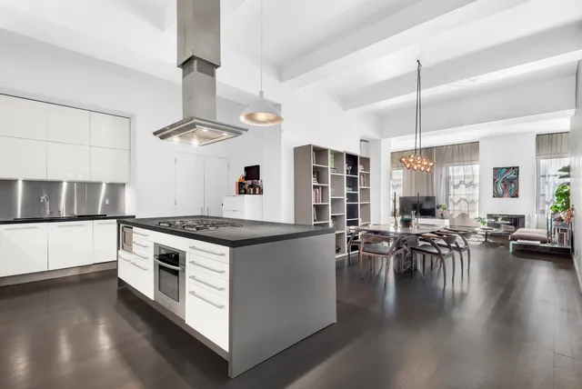 a kitchen with stove and chairs