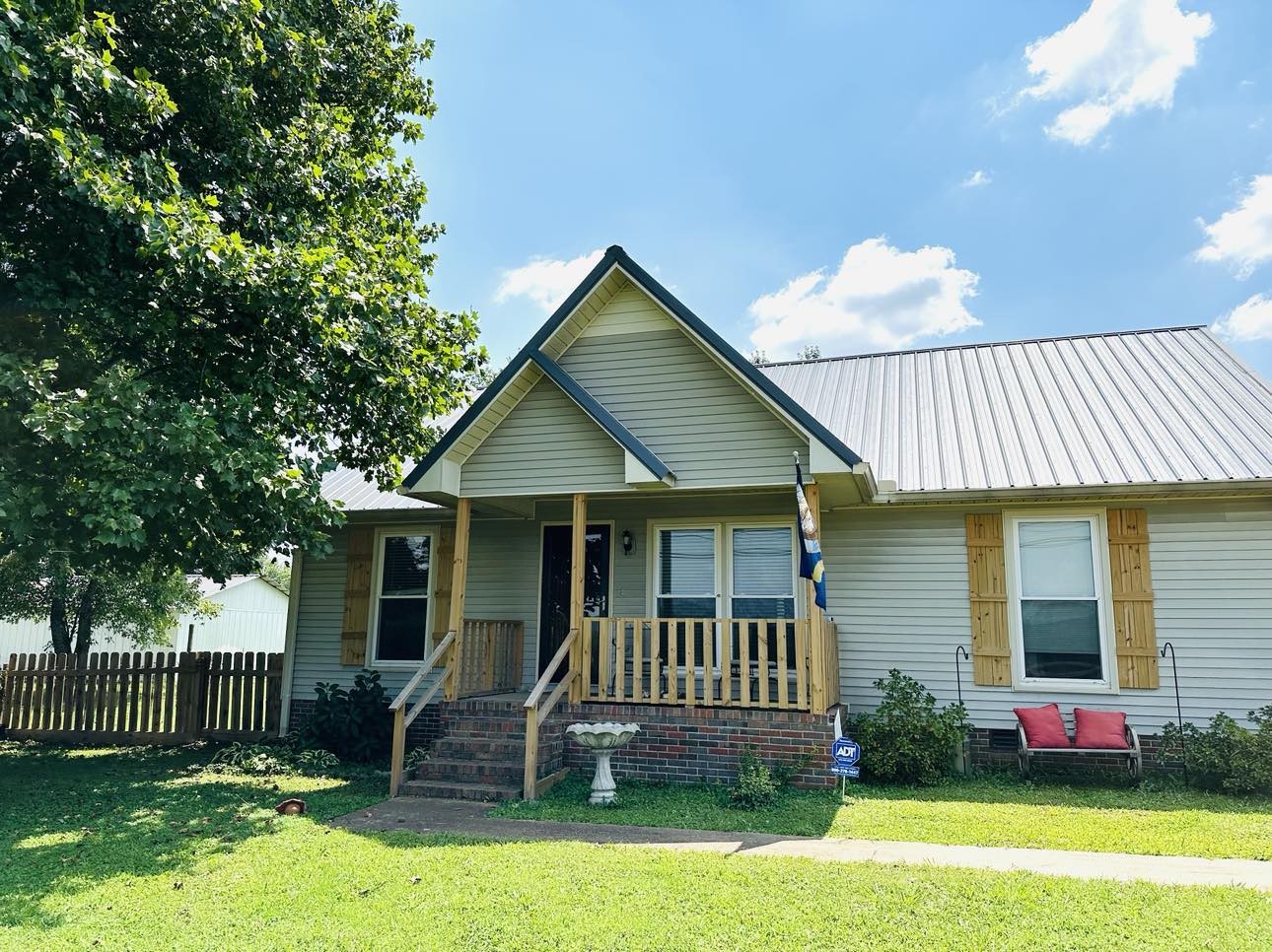 1753 Vales Mill Road Pulaski, TN 38478 - Photo 1 of 14 a front view of a house with garden