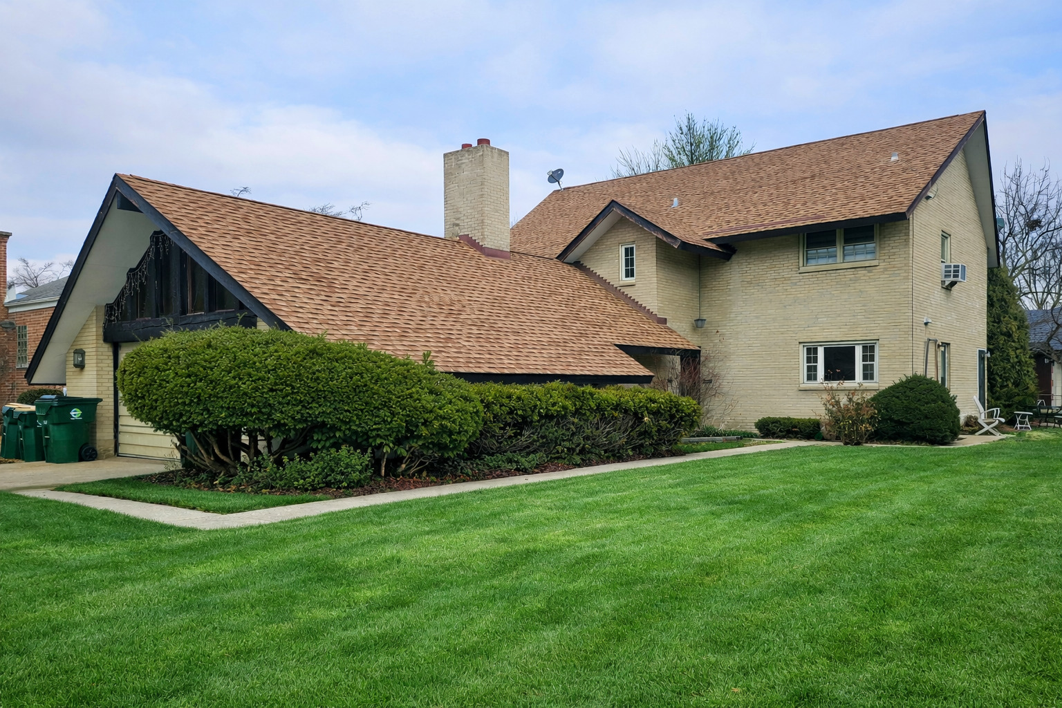 a front view of a house with a garden and plants