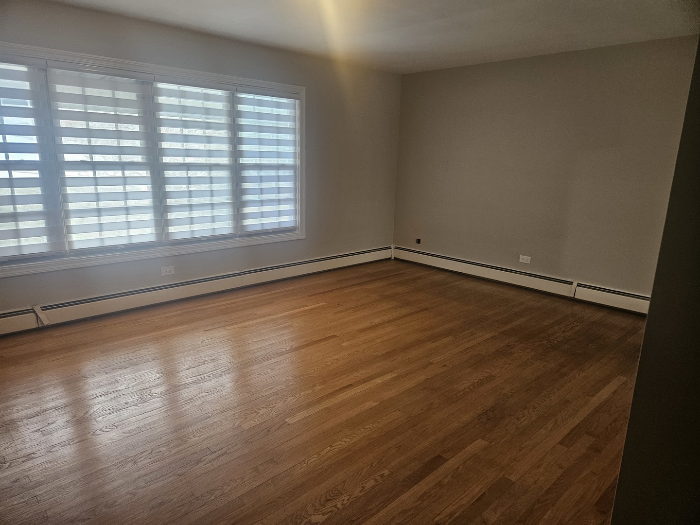 863 North Northwest Highway Park Ridge, IL 60068 - Photo 18 of 31 a view of an empty room with wooden floor and a window