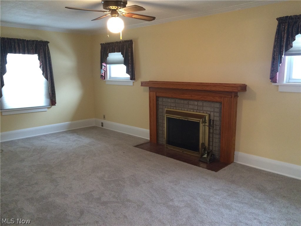 4009 Rosemond Road Cleveland Heights, OH 44121 - Photo 5 of 28 Well lit living room with gas fireplace, carpet March 2017 (hardwood underneath), vinyl windows throughout the home,