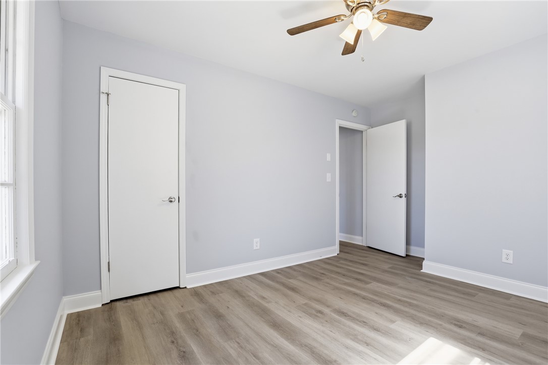 410 Springdale Avenue Liberty, SC 29657 - Photo 18 of 50 This airy bedroom features sleek flooring, a ceiling fan, and ample natural light.