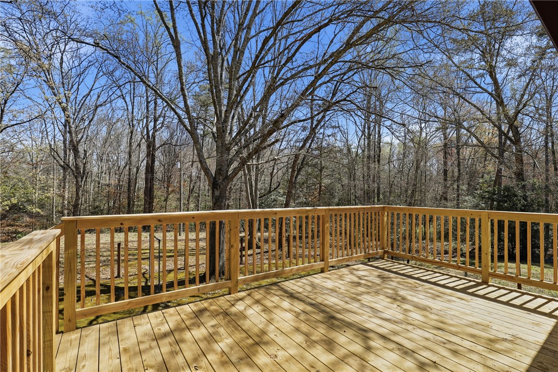 410 Springdale Avenue Liberty, SC 29657 - Photo 21 of 50 This spacious deck offers tranquil views of the surrounding natural landscape, perfect for relaxation.