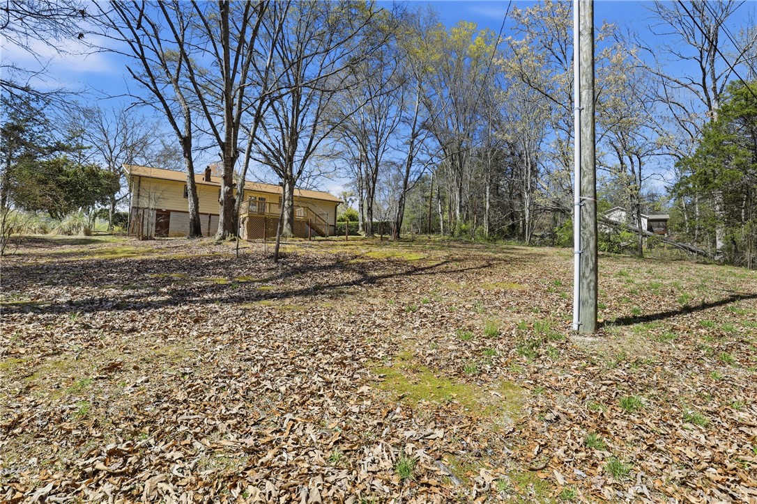 410 Springdale Avenue Liberty, SC 29657 - Photo 24 of 50 This spacious yard offers ample outdoor living potential, surrounded by natural foliage and mature trees.