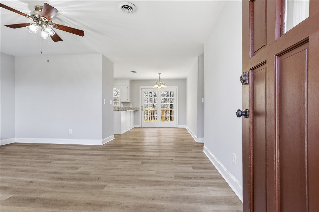 410 Springdale Avenue Liberty, SC 29657 - Photo 3 of 50 Step into a luminous open-concept living space featuring wood flooring and ample natural light.