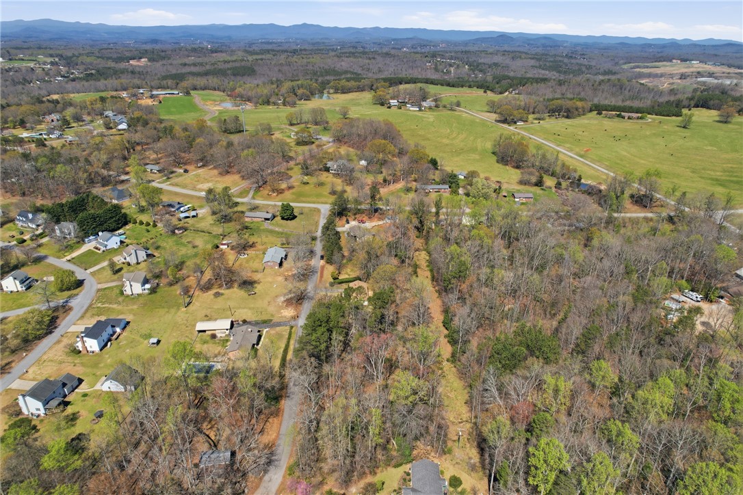 410 Springdale Avenue Liberty, SC 29657 - Photo 36 of 50 This elevated view captures a serene landscape with rolling hills and a scattered residential area.