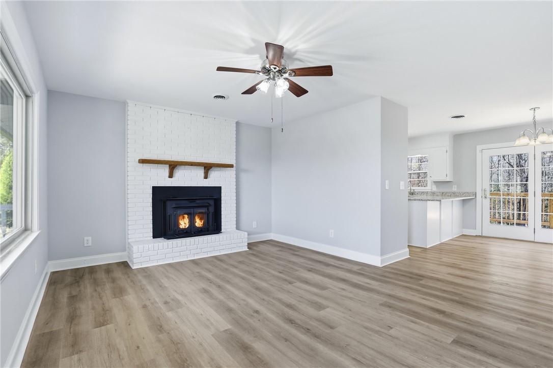 410 Springdale Avenue Liberty, SC 29657 - Photo 4 of 50 This bright room features a warm fireplace and ample natural light, perfect for cozy gatherings.