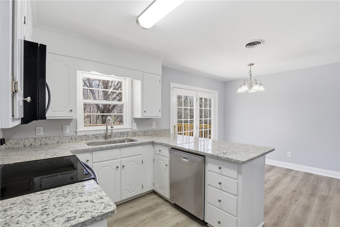 410 Springdale Avenue Liberty, SC 29657 - Photo 10 of 50 Bright and open kitchen with modern finishes and access to outdoor living.