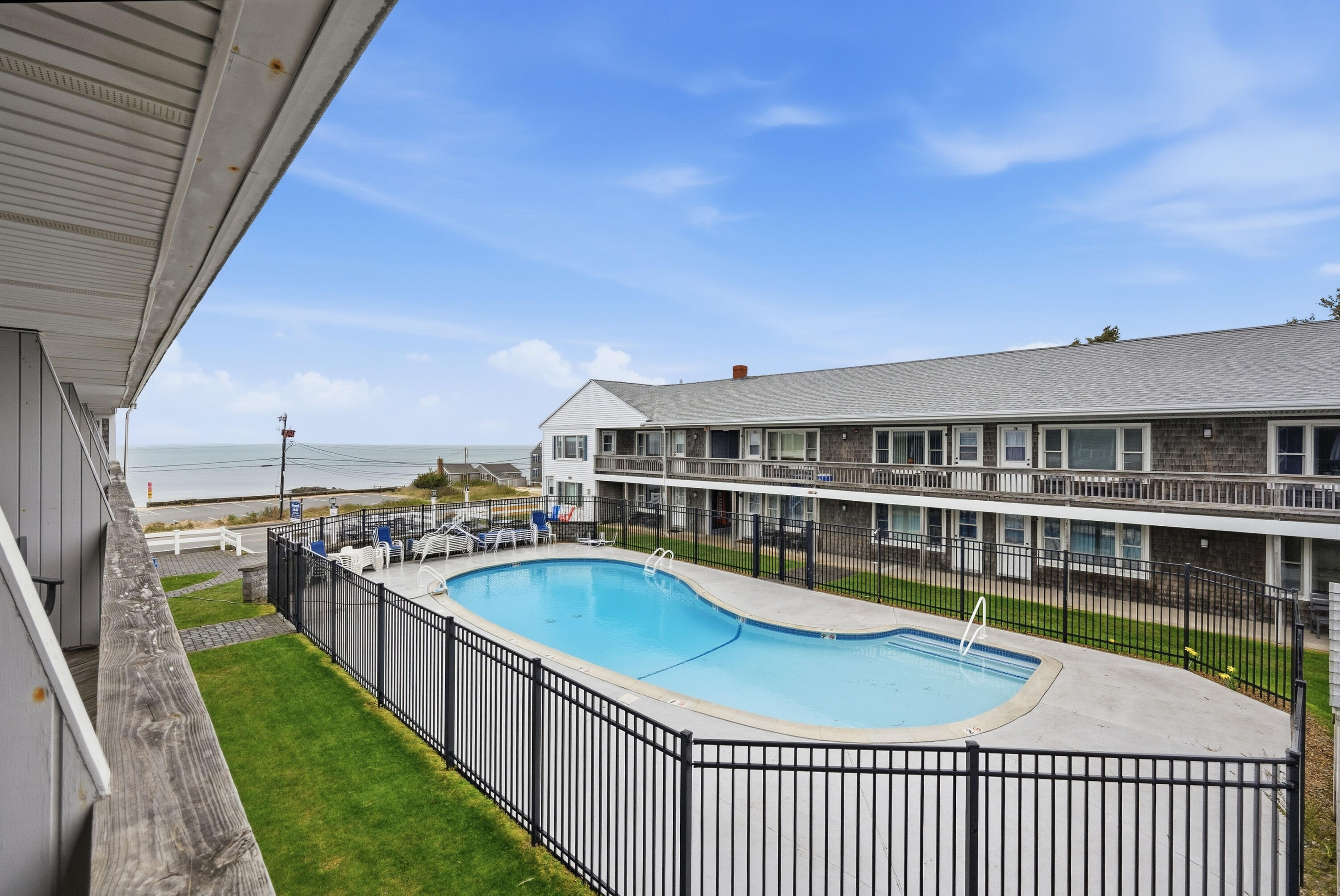 a view of a swimming pool with a deck