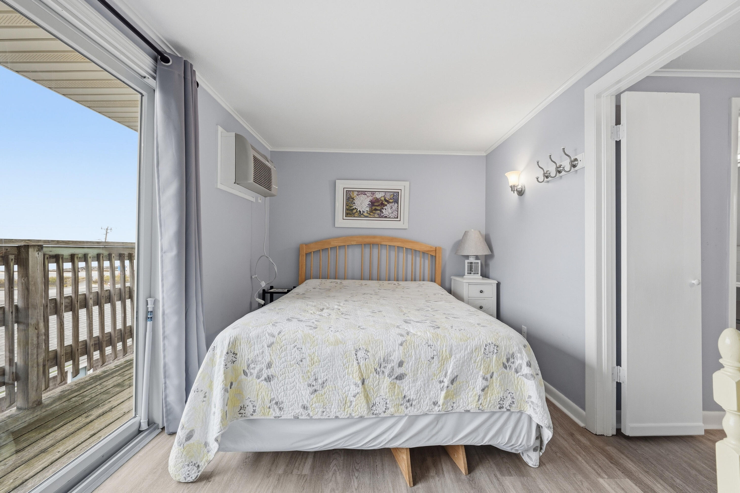 154 Old Wharf Road, Unit 51 Dennis Port, MA 02639 - Photo 3 of 12 a bedroom with a bed and wooden floor