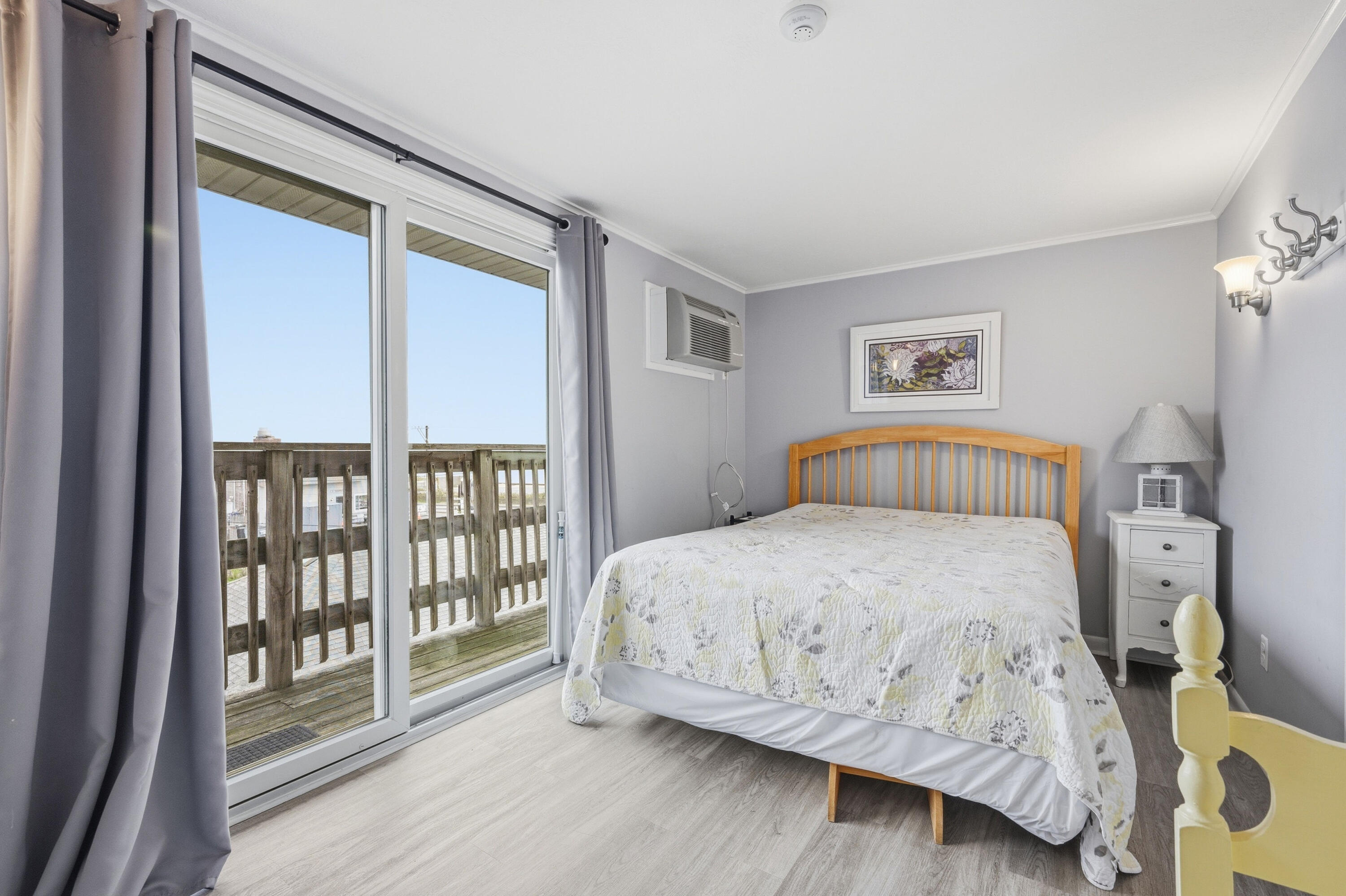 154 Old Wharf Road, Unit 51 Dennis Port, MA 02639 - Photo 4 of 12 a bedroom with a large bed and a large window