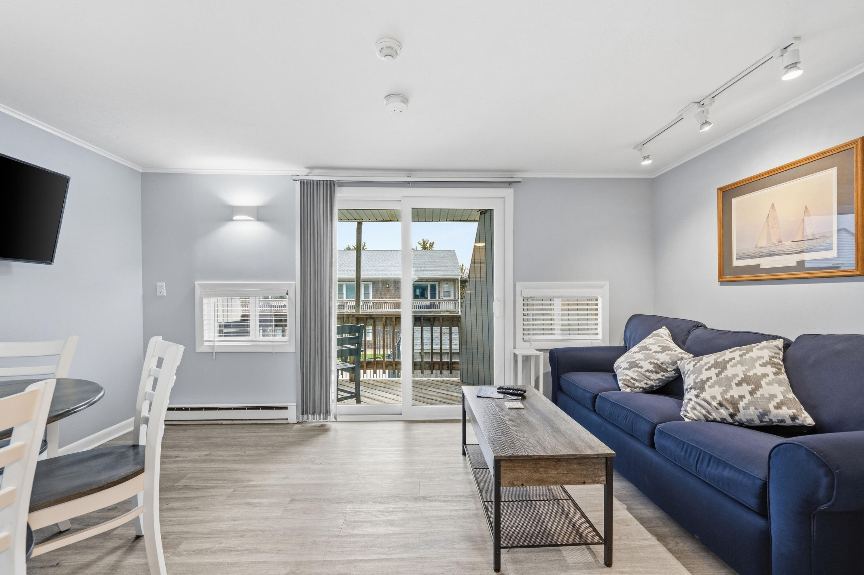 154 Old Wharf Road, Unit 51 Dennis Port, MA 02639 - Photo 7 of 12 a living room with furniture and a flat screen tv
