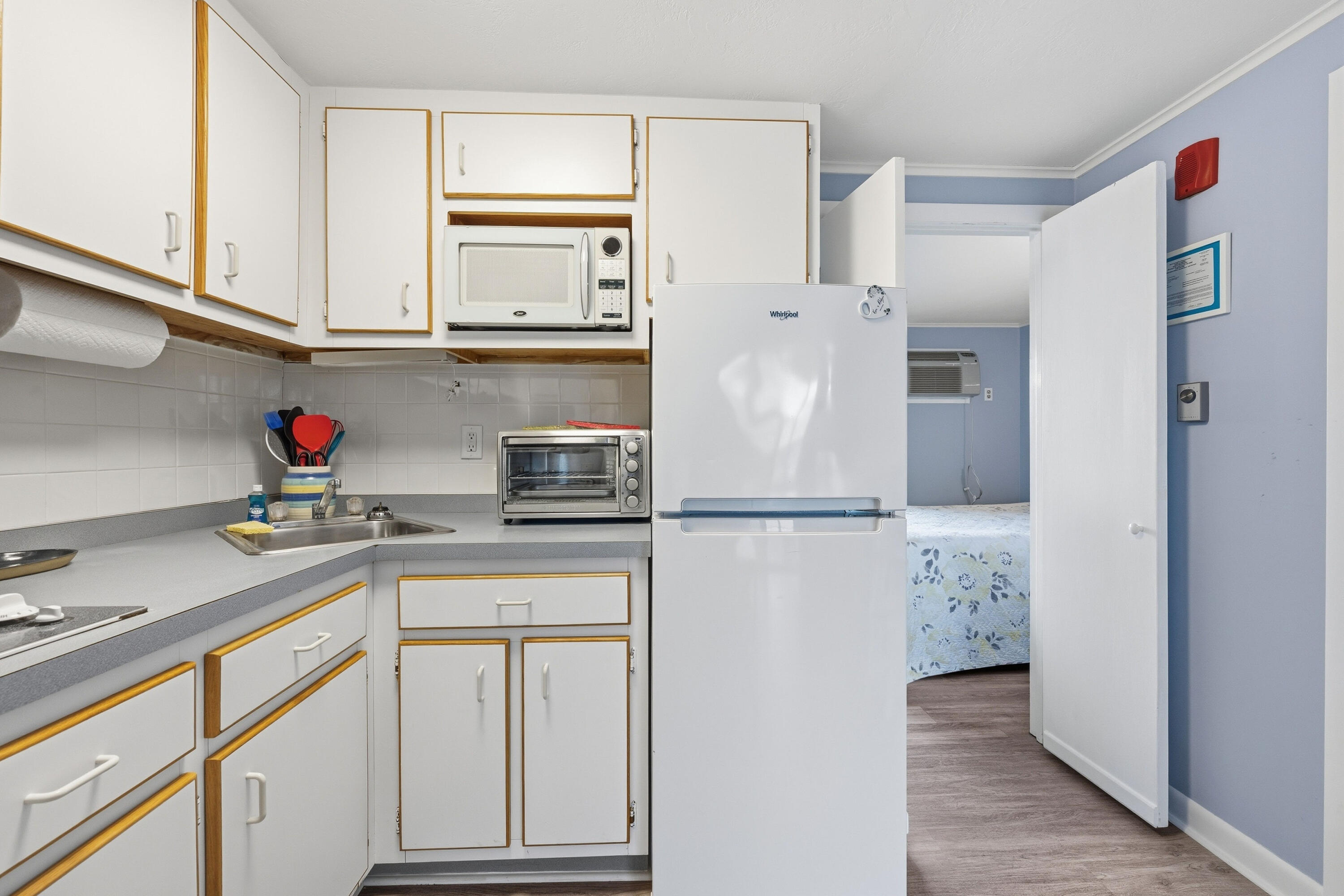 154 Old Wharf Road, Unit 51 Dennis Port, MA 02639 - Photo 9 of 12 a kitchen with stainless steel appliances white cabinets and a refrigerator