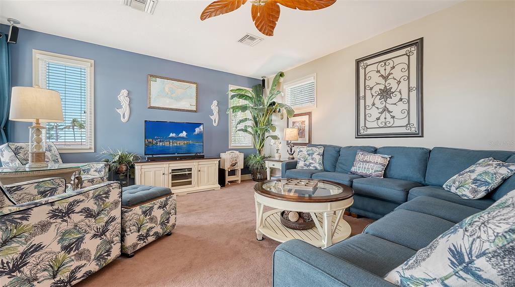 220 36th Street Holmes Beach, FL 34217 - Photo 11 of 59 a living room with furniture a couch and a flat screen tv