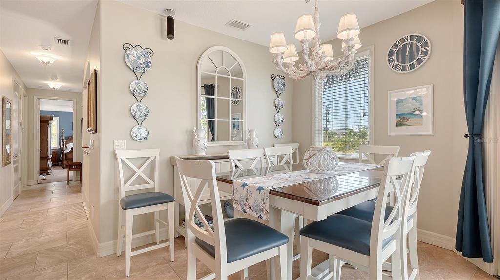 220 36th Street Holmes Beach, FL 34217 - Photo 13 of 59 a view of a dining room with furniture and a chandelier