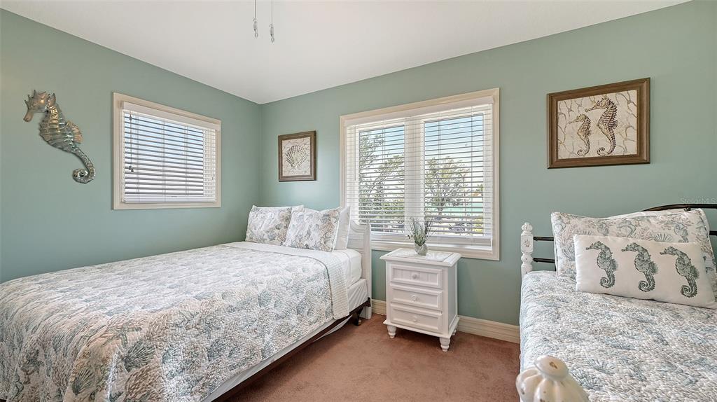 220 36th Street Holmes Beach, FL 34217 - Photo 25 of 59 a bedroom with a bed and a window