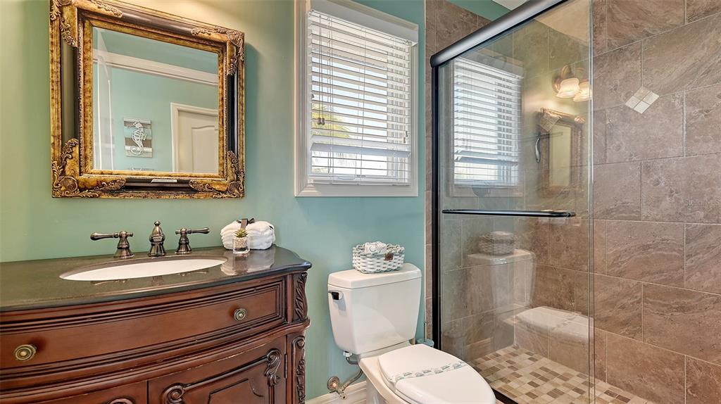 220 36th Street Holmes Beach, FL 34217 - Photo 27 of 59 a bathroom with a sink a toilet and shower