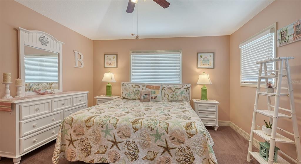 220 36th Street Holmes Beach, FL 34217 - Photo 28 of 59 a bedroom with a bed and wooden floor