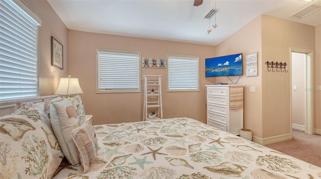 220 36th Street Holmes Beach, FL 34217 - Photo 29 of 59 a bedroom with a bed and a desk