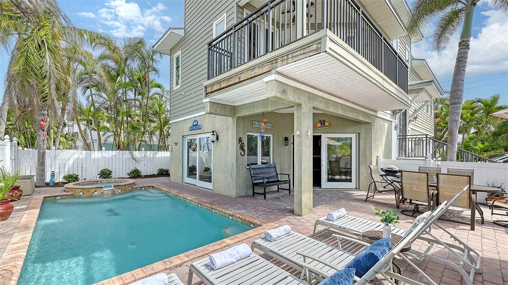 220 36th Street Holmes Beach, FL 34217 - Photo 5 of 59 a backyard of a house with outdoor seating