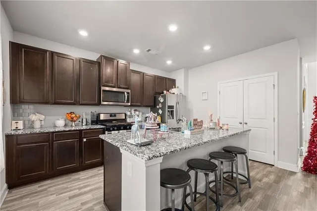 a kitchen with granite countertop a sink and cabinets