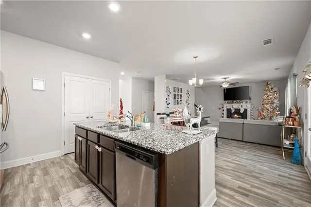 a kitchen with sink cabinets and wooden floor