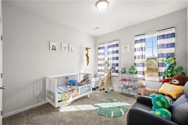 a bedroom with furniture and a large window