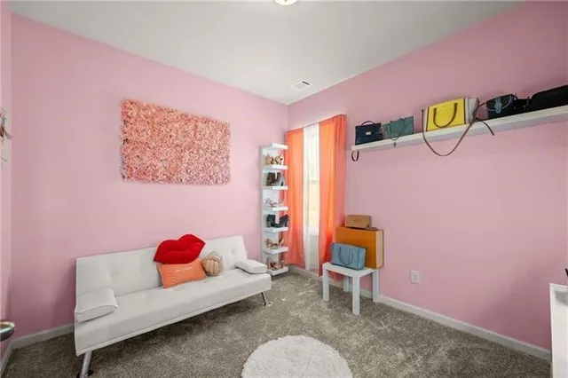 a bedroom with a bed and a chair