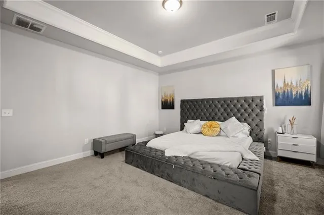 a bedroom with a bed and a couch