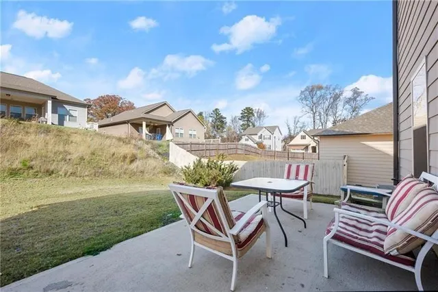 a backyard of a house with table and chairs